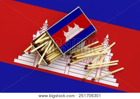 Cambodia Flag  Is Shown On An Open Matchbox, From Which Several Matches Fall And Lies On A Large Fla