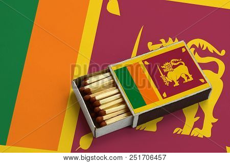 Sri Lanka Flag  Is Shown In An Open Matchbox, Which Is Filled With Matches And Lies On A Large Flag.