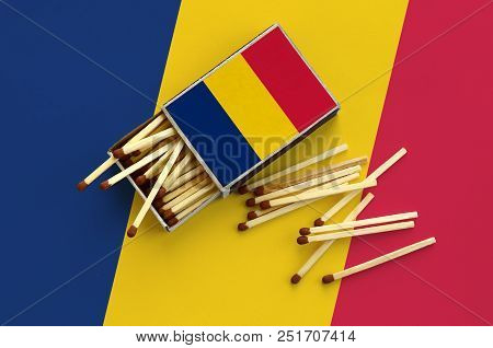 Chad Flag  Is Shown On An Open Matchbox, From Which Several Matches Fall And Lies On A Large Flag.