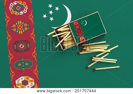 Turkmenistan Flag  Is Shown On An Open Matchbox, From Which Several Matches Fall And Lies On A Large