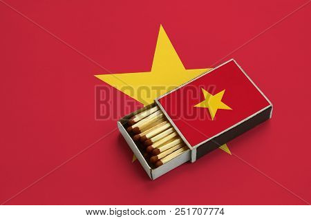 Vietnam Flag  Is Shown In An Open Matchbox, Which Is Filled With Matches And Lies On A Large Flag.