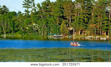 Fishing Boat On Calm Lake Near Resort At Bemidji Minnesota On A Beautiful Evening