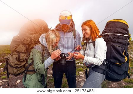 Travel Lifestyle And Survival Concept Rear View. Hiking Man And Women With Backpack Enjoys A Hike  A