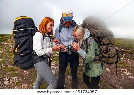 Travel Lifestyle And Survival Concept Rear View. Hiking Man And Women With Backpack Enjoys A Hike  A