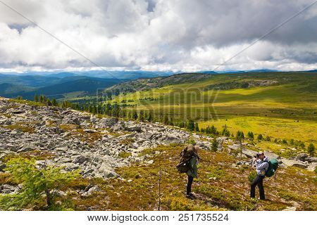 Travel Lifestyle And Survival Concept Rear View. Photographer Traveler, Enjoys A Hike And Photograph