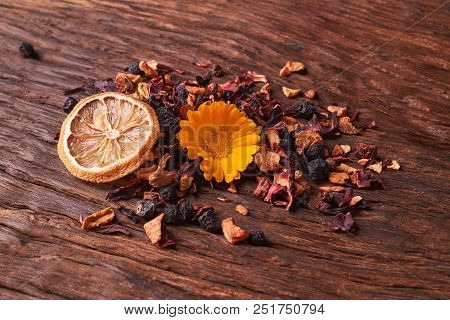 Black Dry Fruit Tea Leaves On Wooden Table
