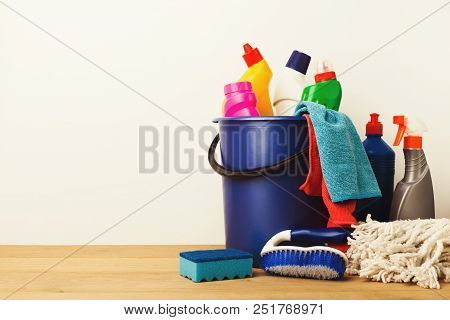 Variety Of House Cleaning Products On Wood Table At White Background, Closeup. Bucket, Brush, Rubber