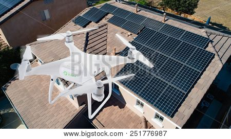 UAV Drone Inspecting Solar Panels On Large House.