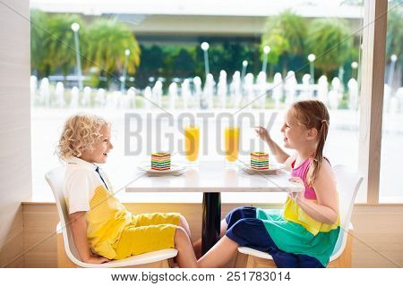 Kids Eat Cake At Restaurant. Boy And Girl In Cafe.