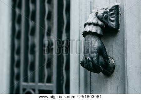 Close-up. Vintage Handle For Knocking On The Door In The Form Of A Hand. Entrance To The Apartment B