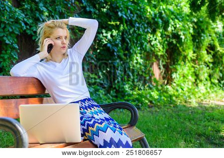 Woman With Laptop Works Outdoors. Business Woman Works Park With Laptop Smartphone. Girl Smartphone 