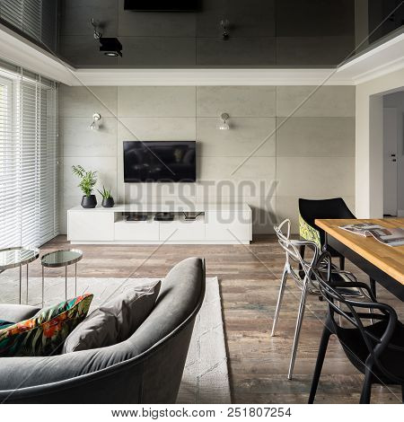 Tv Living Room With Modern Sofa, Wooden Table And Black Stretch Ceiling
