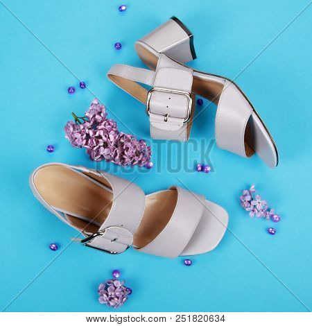Woman Summer Shoes With Accecories On Blue Background