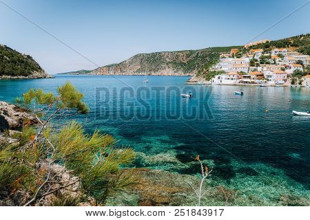 Turquoise Transparent Lagoon Surrounded By Green Pine Trees. Assos Village, Kefalonia Greece. Blue D
