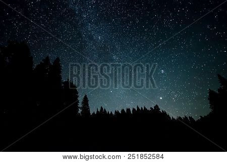 A View Of The Stars Of The Milky Way With A Mountain Top In The Foreground. Night Sky Nature Summer 