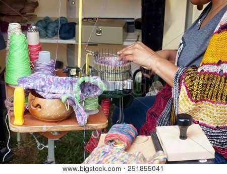 Closeup Of Hands Working With A Circular Sock Knitting Machine, For Making Socks By Hand More Quickl