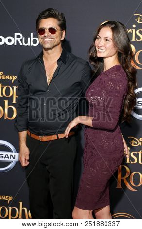 John Stamos and Caitlin McHugh at the Los Angeles premiere of 'Christopher Robin' held at the Walt Disney Studios in Burbank, USA on July 30, 2018.