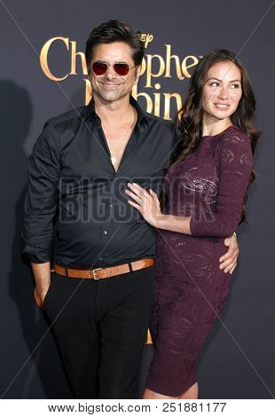 John Stamos and Caitlin McHugh at the Los Angeles premiere of 'Christopher Robin' held at the Walt Disney Studios in Burbank, USA on July 30, 2018.