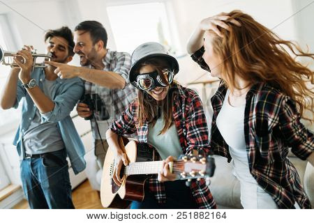 Young Beautiful Happy Dancing Girls Playing Guitar And Partying