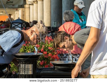 Cracow, Poland - July 5, 2018: Man Is Refreshing At Fountain In Sweltering Hot Days On Main Square I
