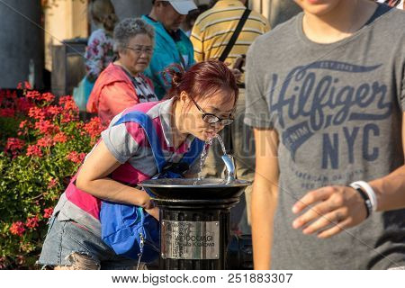 Cracow, Poland - July 5, 2018: Woman Is Refreshing At Fountain In Sweltering Hot Days On Main Square