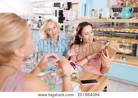 Opening Box. Stylish Appealing Woman With Nice Makeup Feeling Curious While Opening Her Present Box