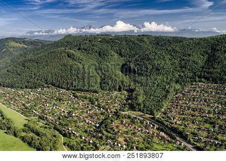 Village And Green Forest. High Tatras Mountains At Background