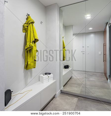 Entryway With Modern Mirrored Wardrobe And White Storage Bench