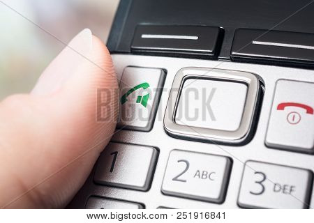 A Male Finger On The Call Button Of A Wireless Dect Telefphone, Ready To Dial Or Activate The Speake