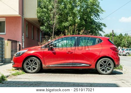Novi Sad, Serbia. July - 31. 2018. New Red Renault Clio Iv Car With Alloy Wheels Parked On The Stree