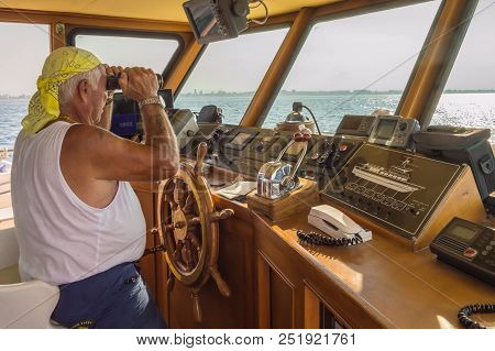 Igea Marina, Italie, Europe-30/07 / 2018.captain In The Post Of A Ship Watching With Binoculars On T