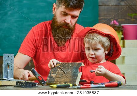 Father, Parent With Beard Teaching Little Son To Use Hobnails And Hammer. Masculine Duties Concept. 