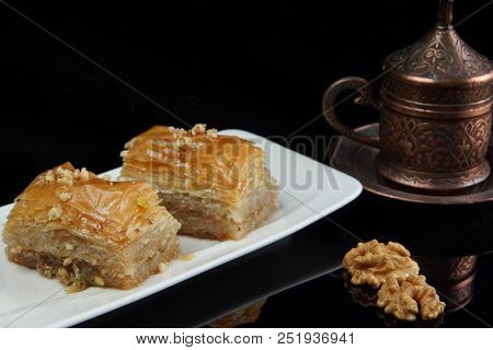 Two Pieces Of Turkish Lakuma Lie On The Table, Next To The Coffee.
