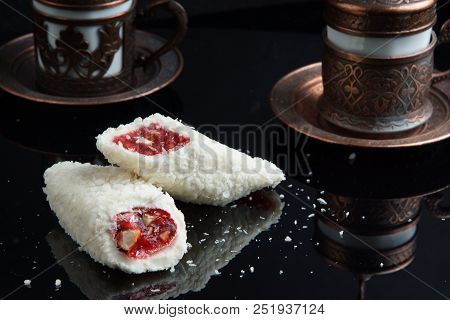 Two Pieces Of Turkish Lakuma Lie On The Table, Next To The Coffee.