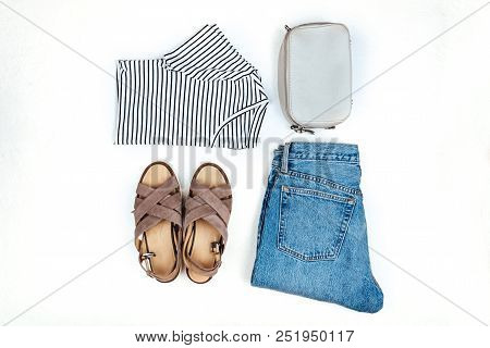 Stylish Female Clothes Set. Girl Outfit On White Background. Blue Jeans, Bag, T-shirt, Sandals. Flat