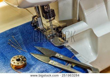 Sewing Machine Repair Jeans Trousers, Close-up.  Sewing Machine Repair Jeans Trousers, Close-up.