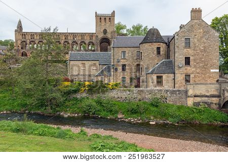 View At Ruins Of Jedburgh Abbey In Scottish Borders. In Front Jed Water River