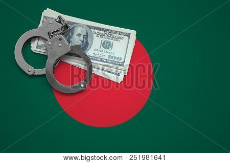Bangladesh Flag  With Handcuffs And A Bundle Of Dollars. The Concept Of Breaking The Law And Thieves