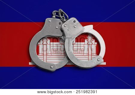 Cambodia Flag  And Police Handcuffs. The Concept Of Observance Of The Law In The Country And Protect