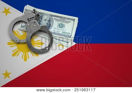Philippines Flag  With Handcuffs And A Bundle Of Dollars. The Concept Of Breaking The Law And Thieve