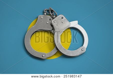 Palau Flag  And Police Handcuffs. The Concept Of Observance Of The Law In The Country And Protection