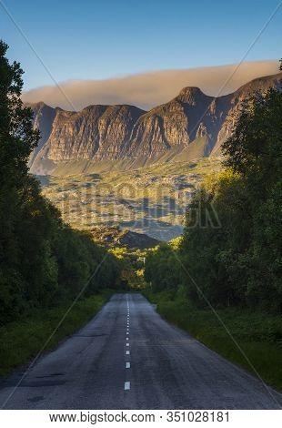 The Mountain Range Of The Knockan Crag National Nature Reserve At Sunset, Seen From The Two-lane Hig