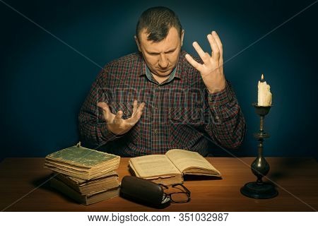 The Man Reads The Book. In The Head Images Similar To Reality Are Born. Fascinating Literary Work. T