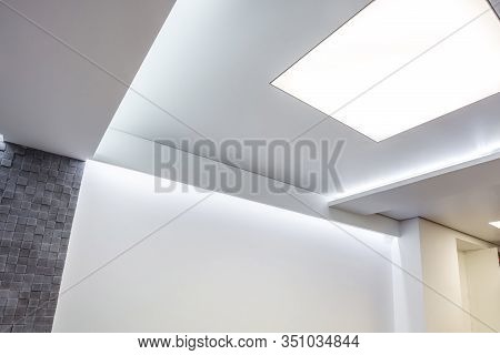 Halogen Spots Lamps On Suspended Ceiling And Drywall Construction In In Empty Room In Apartment Or H
