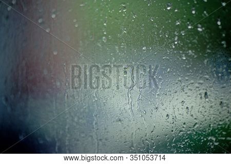 Moisty Wet Window With Water Running Down The Surface. Window Glass After Heavy Rain. Abstract Blurr