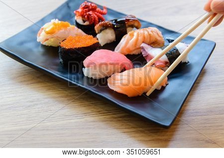 Salmon Sushi With Chopstick And Nigiri Sushi Set On Clay Plates