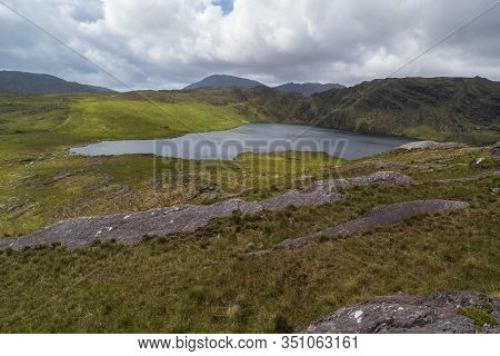 A Lake On The Top Of A Mountain Surrounded By Wild Mountain Landscape.