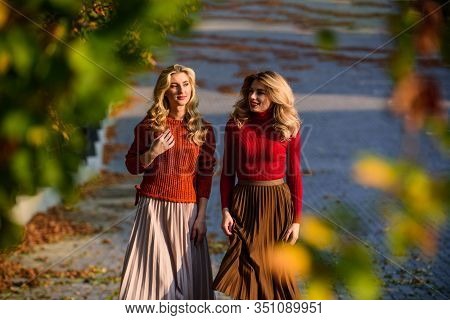 Colorful Fall. Female Beauty. Real Femininity. Autumn Women Outdoor. Girl Friends Walk In Park. Sunn