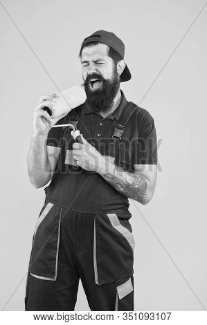 Industrial Concept. Creative Repair Concept. Bearded Man Singing In Roller Tool. Hipster Builder In 