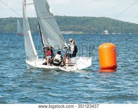 Young Boys Sailing / Racing Small Sailboat, Rounding An Orange Marker. Teamwork By Junior Sailors Ra